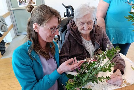 Ergotherapeutin Eva Kastenhofer mit Bewohnerin binden Palmbesen