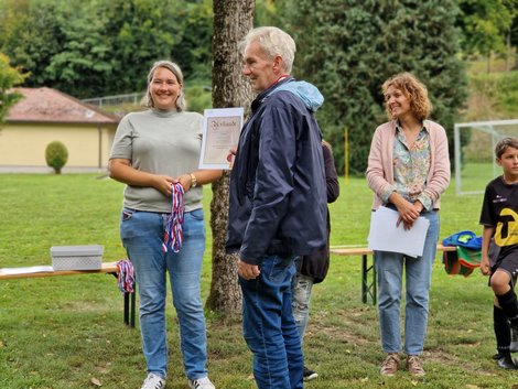 Fußballspieler erhält Urkunde für Teilnahme
