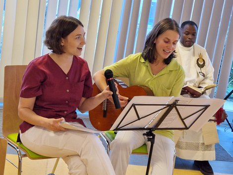 Verena und Beatrix beim Musizieren, im Hintergrund Pfarrer Andrew