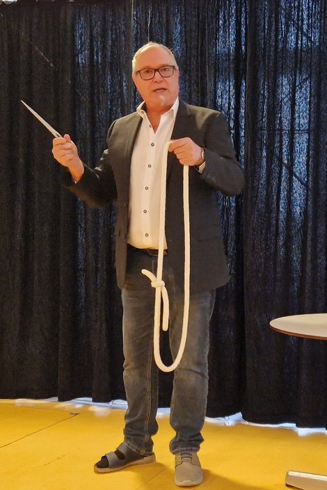 Zauberer mit Seiltrick und Schere