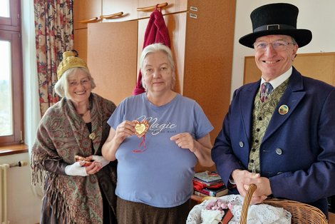 Weibliches und männliches Mitglied des Gmundner Trachtenvereins mit Bewohnerin