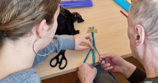 Schülerin und Bewohner beim Flechten