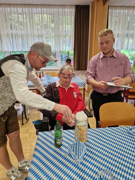 Bewohner und 2 Mitarbeiter beim Maiskorn-Schätzspiel